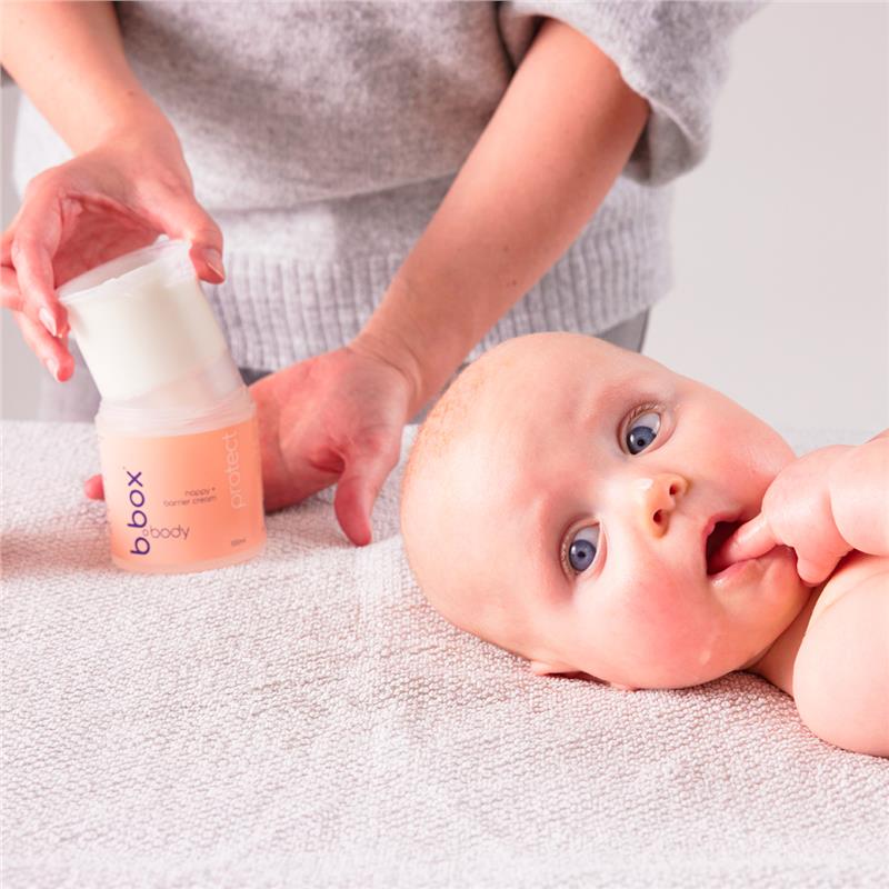 Mother using the Protect Nappy and Barrier Cream (100ml) for her baby