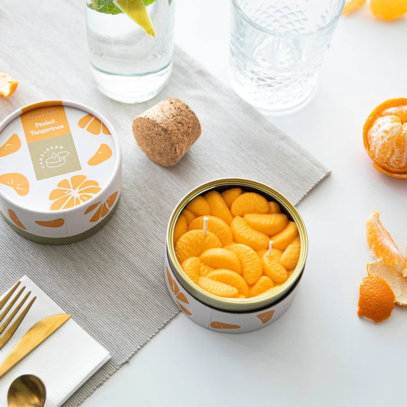 Unique Gourmet Food Candle - Candlecan Peeled Tangerines Candle Hand with oranges and peels on the table