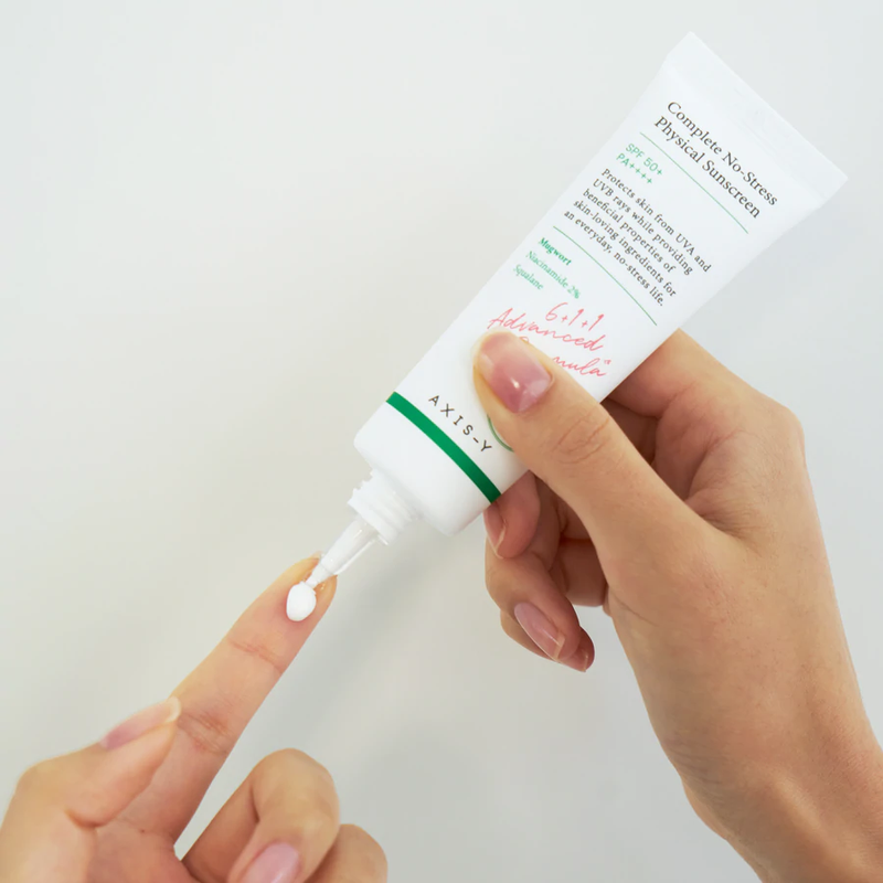 Woman taking sunscreen on her finger for sun protection- Complete No-Stress Physical Sunscreen (50ml)