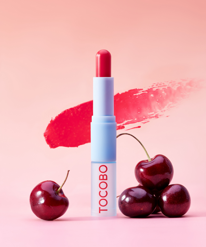 Glass Tinted Lip Balm with cherries in a pink background -Glass Tinted Lip Balm 011 Flush Cherry