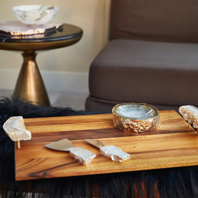 Beautiful Gold Cascita Bowl on a wooden tray next to Sofa - By Anna New York