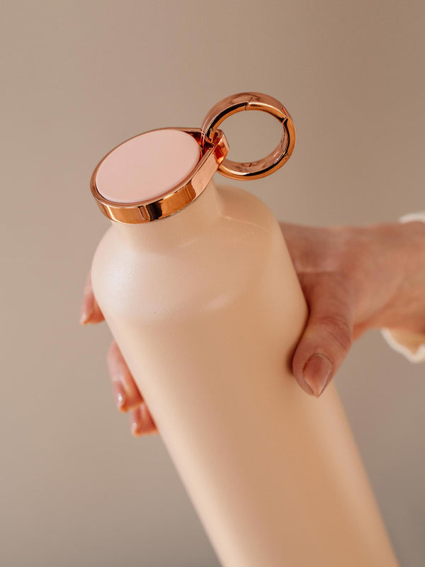 Woman holding a Pink Blush Stainless Steel Bottle - By Equa 
