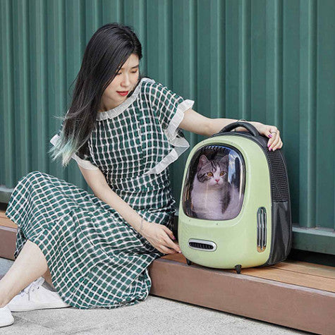 Woman holding a PetKit Smart Cat Carrier with her cat in it- Green